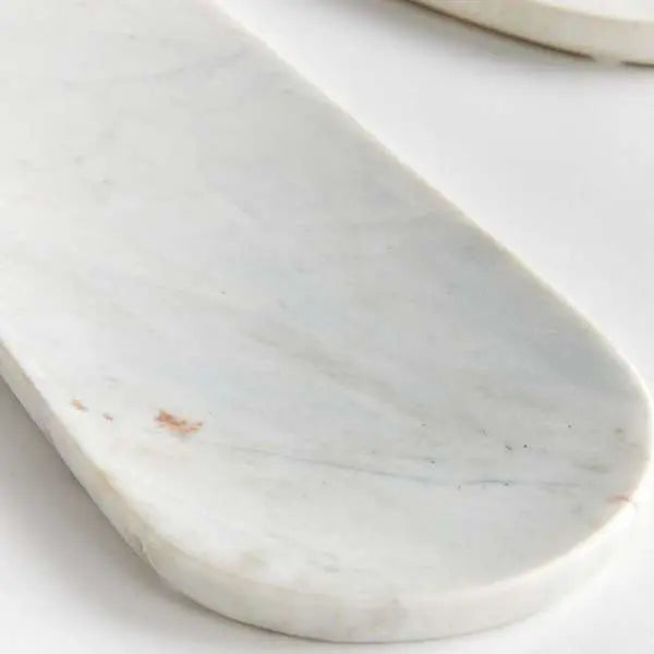 A set of two oval white marble trays, with a large and small tray displayed together, showcasing the unique natural veining in the stone.