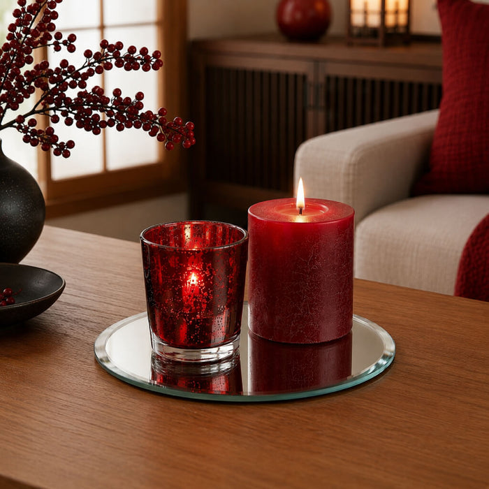 Red candles in a glass holder and pillar on a 5 inch round mirror tray