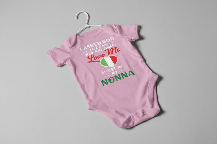 Pink baby onesie with text on a gray background