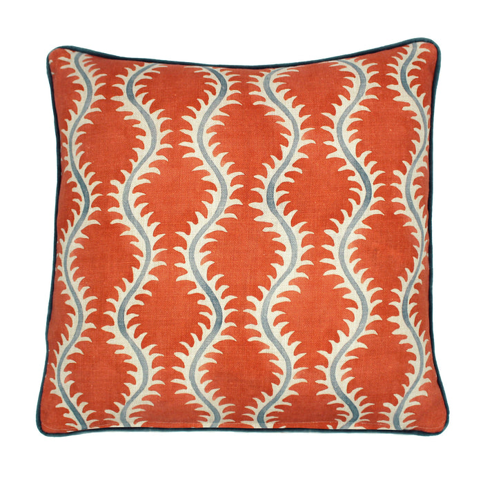 A orange, cream and blue linen cushion with a all-over repeat pattern and velvet piping.