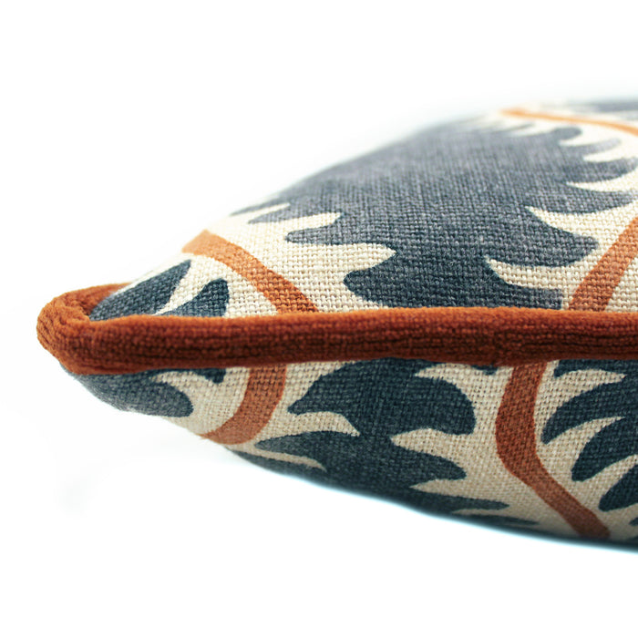 A blue, orange and cream linen cushion with a all-over repeat pattern and linen piping.