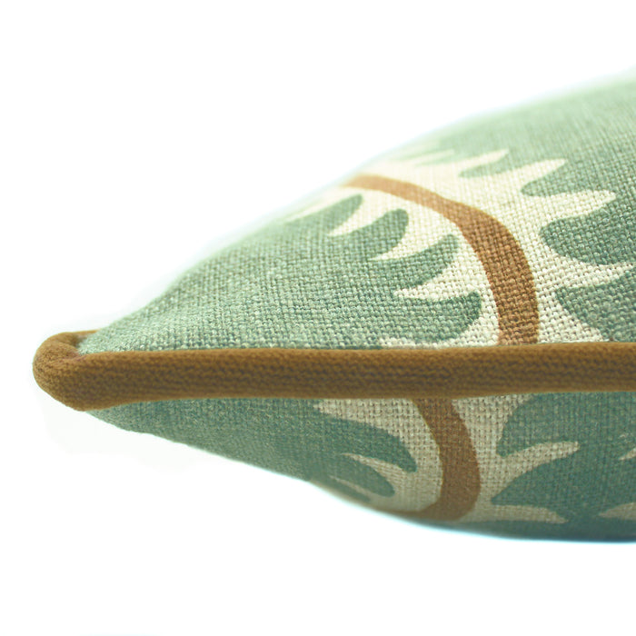 A green, brown and cream linen cushion with a all-over repeat pattern and velvet piping.