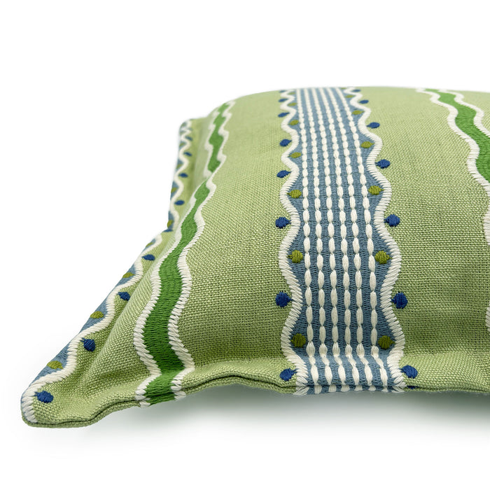 Embroidered cushion with blue and green stripes.