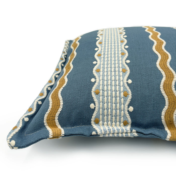 Decorative pillow with blue, gold, and white striped pattern.