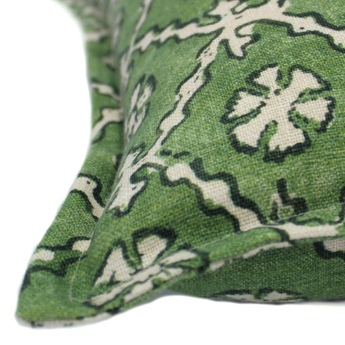 A green and cream linen cushion with a traditional Uzbekistan hand block prints pattern.