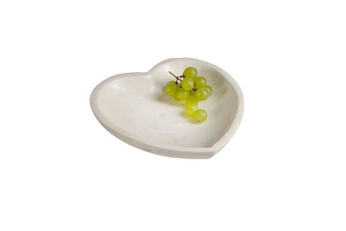 A large, heart-shaped decorative bowl carved from a solid piece of white marble with subtle natural veining and a smooth, polished finish.