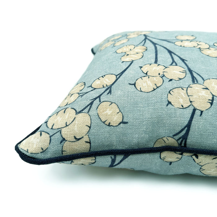 Close-up side view of Linwood cushion in Lottie, Sky showing fabric texture and piping in a strong dark blue linen.