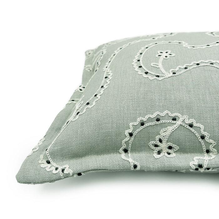 Decorative cushion with a free-flowing floral pattern on a light blue background.