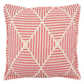 Pink cushion with geometric red pattern.