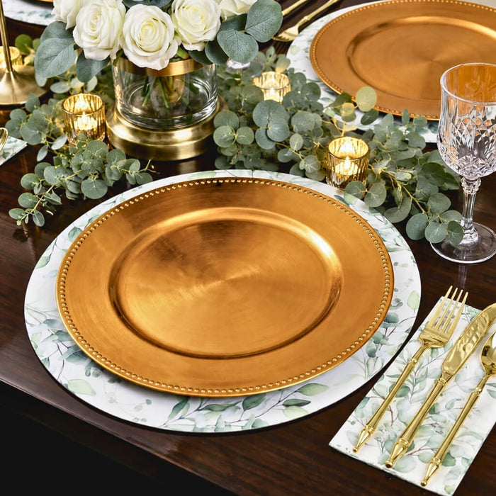 13" gold beaded charger plate on a botanical placemat and wooden table