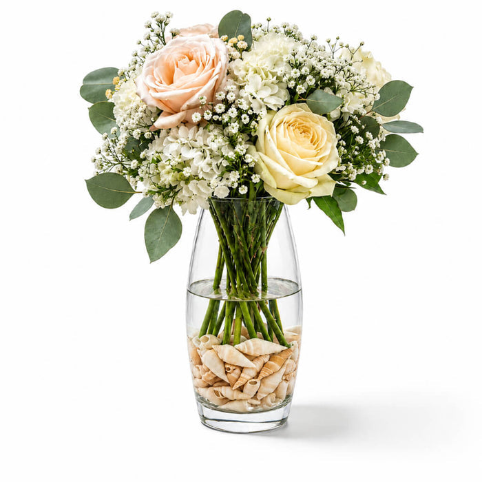 Flower bouquet with Conch Shell Vase Filler in a glass vase