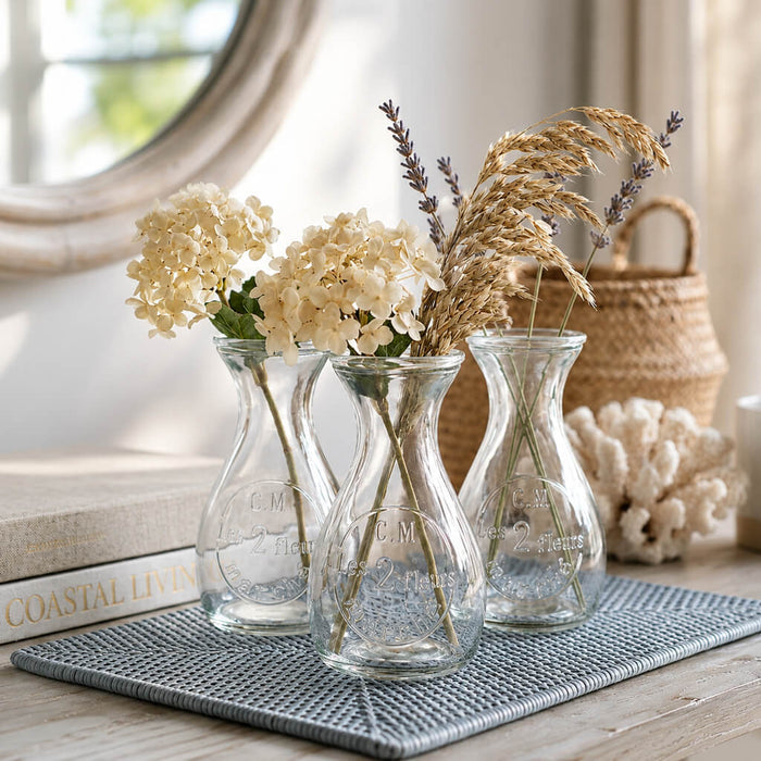 Lit candle in a rose gold mercury hanging mason jar with a beaded handle