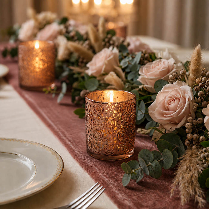 Rose gold mercury candle holders on elegant floral dinner table centerpiece