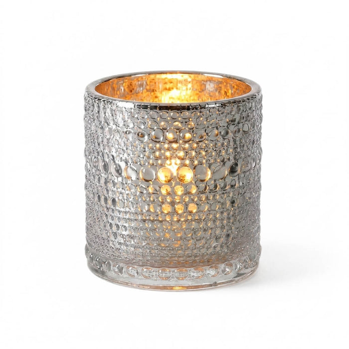 Pearly silver candle holder with glowing light on white background