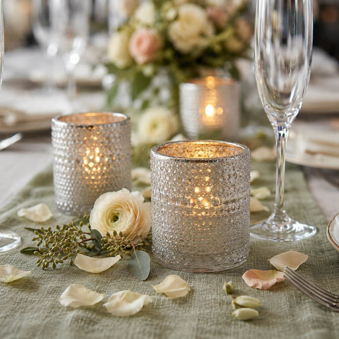 Pearly silver candle holders with floral decor on an elegant dining table