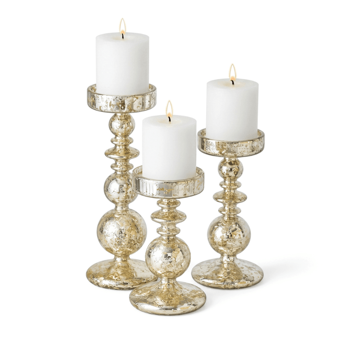 Set of unique mercury bubble pillar candle holders with lit white candles