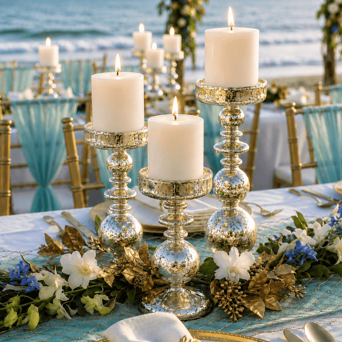 Unique mercury bubble pillar candle holders with lit candles on a beach event tablescape