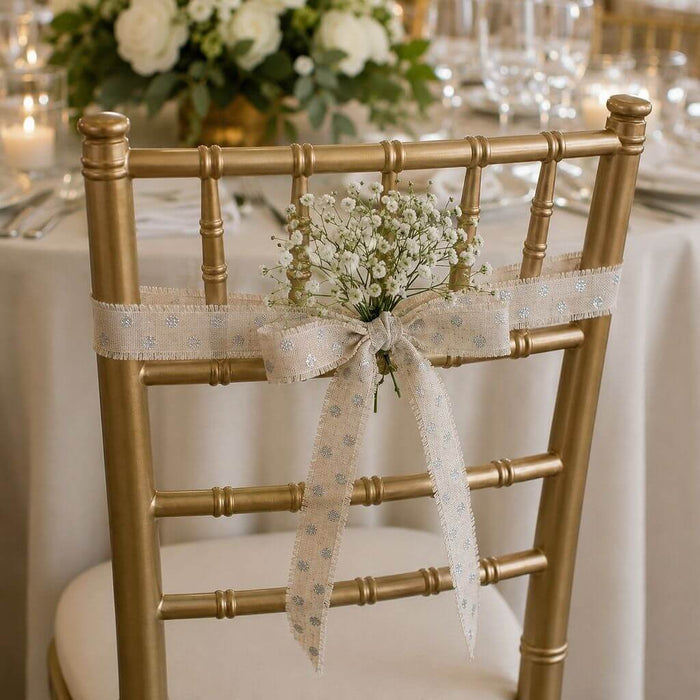 Gold chair decorated with linen ribbon and baby's breath