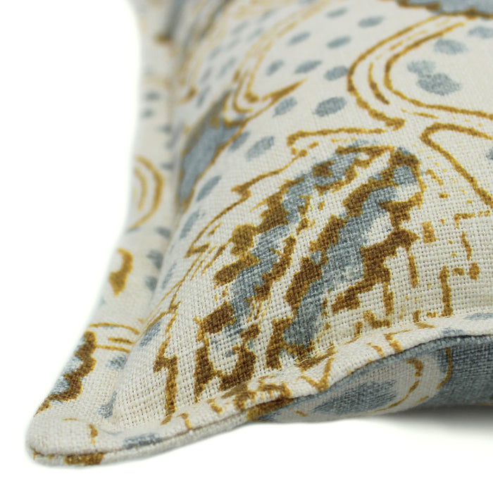 A blue, brown and cream linen cushion with a stylised floral pattern.