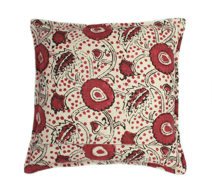 A red, black and cream linen cushion with a stylised floral pattern.