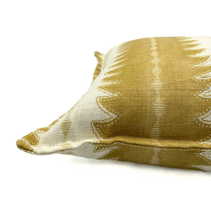 Gold linen cushion with a fern pattern.