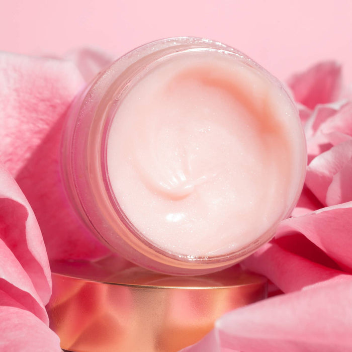 Jar of cream on a pink background with flowers