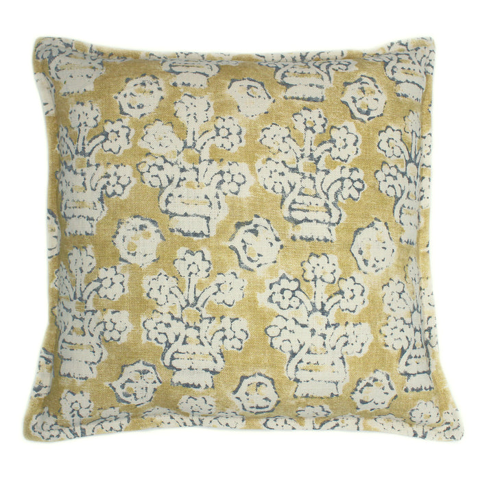 A yellow, blue and cream linen cushion with a block print pattern.