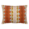 Decorative cushion with geometric pattern in rust, blue and ochre.