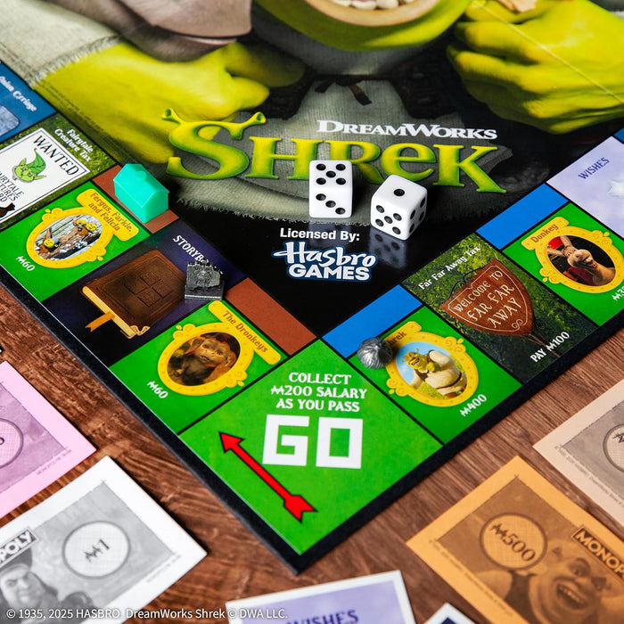 Shrek-themed board game with dice and cards on a wooden surface