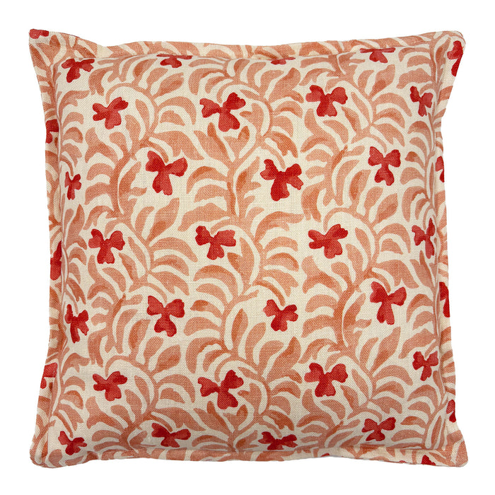 Decorative cushion with a red and pink floral pattern.
