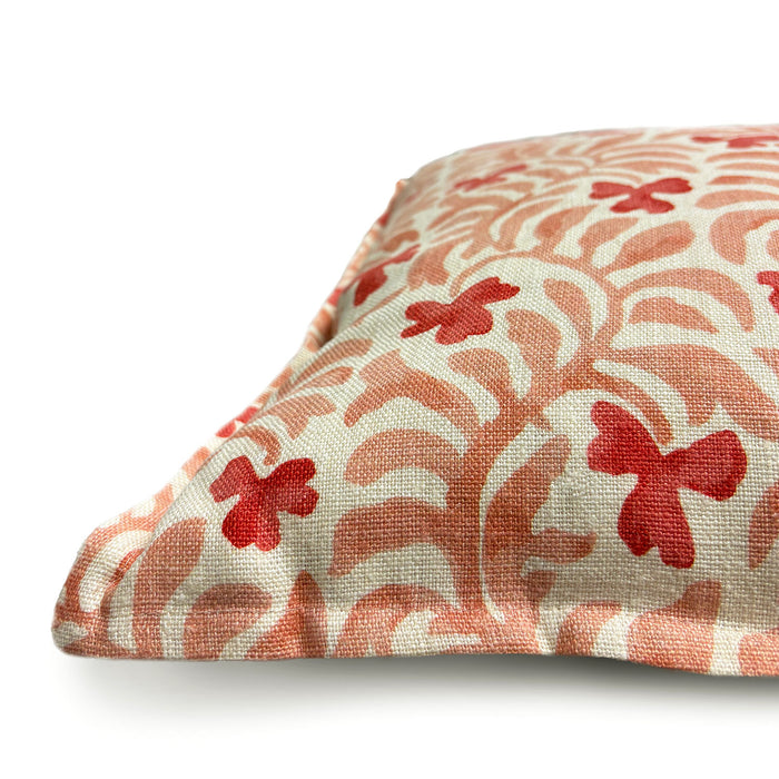 Decorative cushion with a pale blue and green floral pattern.